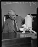 Judge William T. O'Donnell with an electronic appliance, 1930s