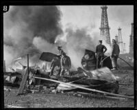 Workers in an oil field during a fire, Santa Fe Springs, 1928