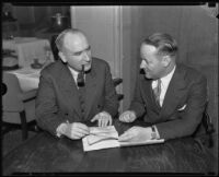 Frank E. O'Neill and A. H. Rude looking over a document, Los Angeles, 1930