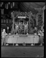 Two women stand in front of the Pomona display at the National Orange Show, San Bernardino, 1933
