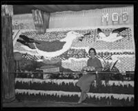 Woman sits on the Mutual Orange Distributors' display at the National Orange Show, San Bernardino, 1934