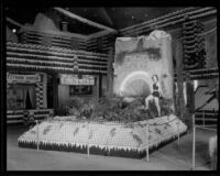 Irene Hatcher stands Ontario's display at the National Orange Show, San Bernardino, 1934