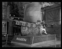 Four women pose on the Pasadena display at the National Orange Show, San Bernardino, 1930