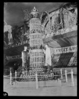 Two women stand beside the Pasadena display at the National Orange Show, San Bernardino, 1926