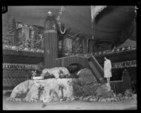 Woman stands next to the Riverside display at the National Orange Show, San Bernardino, 1926