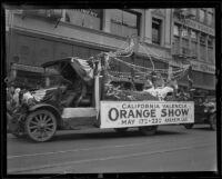 Truck bearing a banner advertising the Valencia Orange Show, 1921