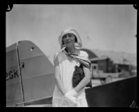 Neva Paris beside a plane, Los Angeles, 1930