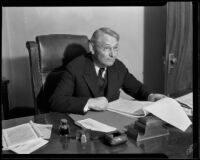 Superior Judge Parker reviews legal documents at his desk, Los Angeles, 1932