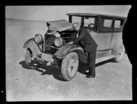Unidentified man working on car, circa 1934