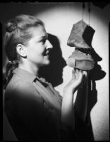 Betty Hanna with child-size shoes, Santa Monica, 1941