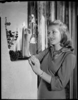 Betty Hanna lighting candle, Santa Monica, 1941