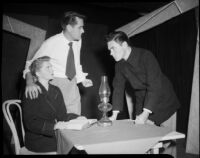 Two men and woman at small table, possibly acting in a play, [Santa Monica?], 1951