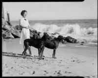 Ruth Bertrand on beach with dogs, Long Beach, 1940