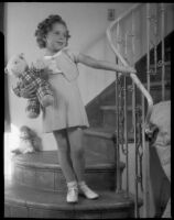 Sylvia Arslan on stairway with stuffed animal, [1938-1939?]