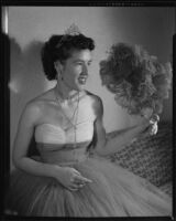 Opera singer Diane Houck Malin wearing a tulle gown, with tiara and fan, 1956