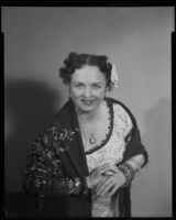 Mezzo soprano June Moss wearing shawl and flower, 1956