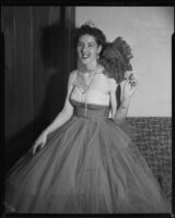 Opera performer Diane Houck Malin wearing a tulle gown with tiara and fan, 1956