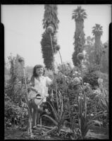 Helena Burnett watering flowers, 1947-1950