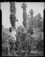 Helena Burnett watering flowers, 1947-1950