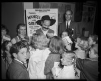 "Hansel and Gretel" cast member Barbara Ludwig and fellow performer signing autographs, Santa Monica, 1959