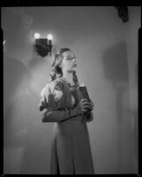 Opera singer from performance of Faust, holding a book, Santa Monica, 1960