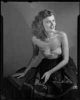 Miriam Braun, poses in skirt and strapless top, 1949