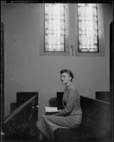 Miriam Braun, seated in a church, 1949