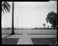 View of street, cliffs and ocean, likely on Ocean Ave., Santa Monica, circa 1952