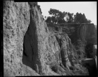 View of cliffs of Palisades Park behind the Sorrento Beach Club, Santa Monica, 1952