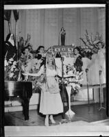 Performer Etilka Dessy at Del Mar Club with children and nun, Santa Monica, 1952