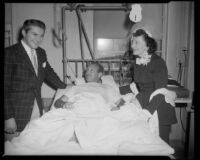 Liberace and Lee Banning Morris visit a veteran at the V.A. hospital, Los Angeles, [1952-1953]