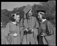 Los Angeles High School seniors Audrey Probst, Norman Tyre and Nancy Lou Pederson in caps and gowns, Los Angeles, 1940
