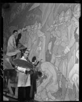 Dean Cornwell and assistant painting a mural below the rotunda at the Los Angeles Central Library, Los Angeles, 1932