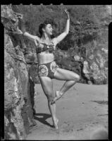 Leonora Preston posing with her working leg in retiré devant position at the beach, Santa Monica, 1951