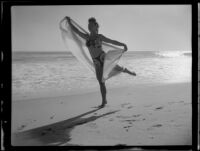 Leonora Preston in first arabesque position at the beach, Santa Monica, 1951
