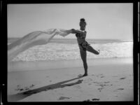 Leonora Preston en attitude with scarf at the beach, Santa Monica, 1951