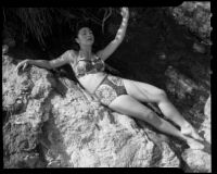 Leonora Preston posing on rock at the beach, Santa Monica, 1951