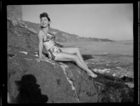 Leonora Preston posing on a rock at the beach, Santa Monica, 1951