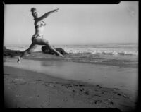 Leonora Preston performing a grand jeté at the beach, Santa Monica, 1951