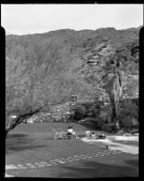Guests relaxing at the poolside lawn at the Palm Springs Tennis Club, Palm Springs, 1941