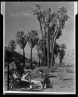 Paul P. Wilhelm and a woman cooking out at 1000 Palms Ranch, Thousand Palms vicinity, 1939