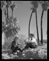 Paul P. Wilhelm and Marcella seated against a desert backdrop at 1000 Palms Ranch, Thousand Palms vicinity, 1939