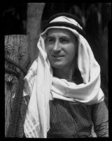 Paul P. Wilhelm dressed in Arab style clothing at 1000 Palms Ranch, Thousand Palms vicinity, 1939
