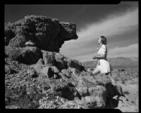 Dorie Doney looking at a rock formation at 1000 Palms Ranch, Thousand Palms vicinity, 1941