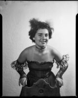Barbara Lee Tramutto in Spanish-style costume leaning on chair, Santa Monica, 1951
