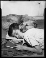 Boy and dog resting on doormat, [1940s or 1950s?]