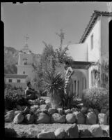 Woman and man in rock garden, El Mirador Hotel, Palm Springs, 1935