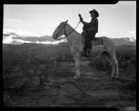 Cowboy on horse with guitar at sunset, Palm Springs, [1930s or 1940s?]