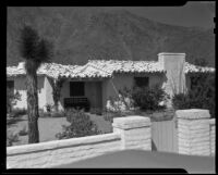 House with tiled roof, garden, and gated wall, Palm Springs, [1930s or 1940s?]