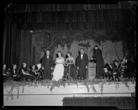 Ray Gagan, June Moss, Natalie Garrotto and Enrico Porta with orchestra onstage, perhaps for a United Nations event, circa 1950